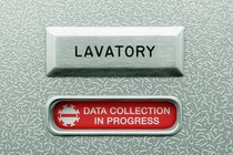 Illustration of an airplane lavatory door that says "data collection in progress"