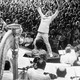 A black-and-white photograph of Leonard Bernstein conducting an orchestra in front of a crowd