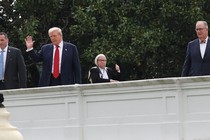 Donald Trump waving from a roof