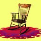 An image of an empty rocking chair with a covid particle underneath.