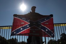 A man holding a Confederate flag