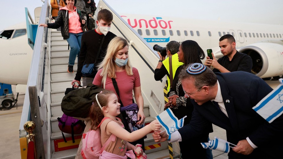 Passengers disembark from an airplane carrying Jewish immigrants fleeing the war in Ukraine, upon their arrival in Israel.