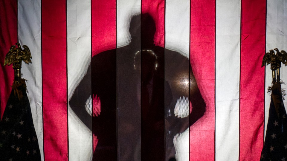 A news photo of a looming shadow of Donald Trump's figure.