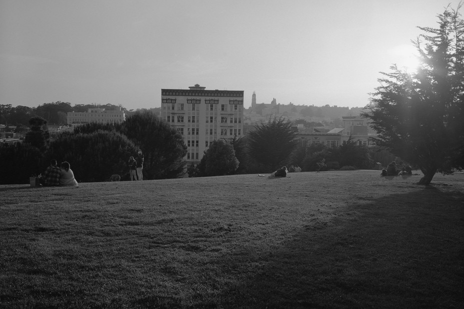 people relax at sunset in a park