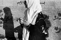 A women silhouetted against a mural