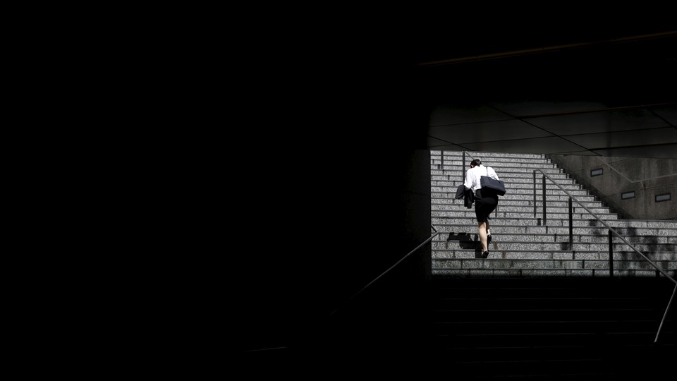 A woman climbs a set of stairs.