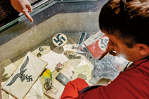 A photograph of children looking at Nazi artifacts