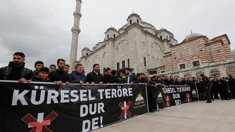 People take part in a demonstration against the Christchurch attack following Friday prayers in Istanbul, Turkey. The banners read "Say No to Global Terror!"