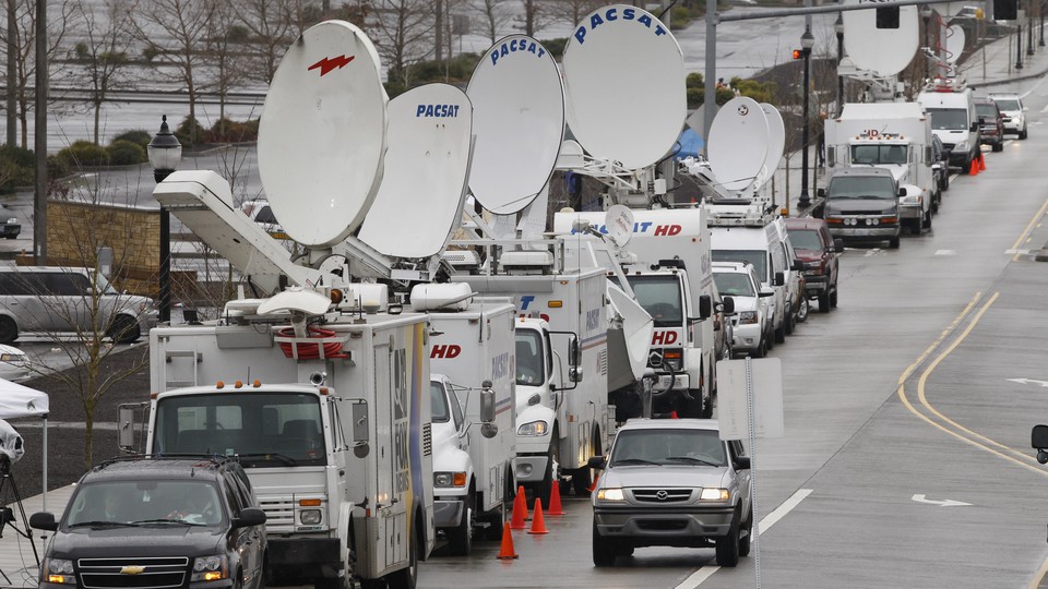 Television satellite trucks line an Oregon roadway near the scene of a mall shooting in 2012.