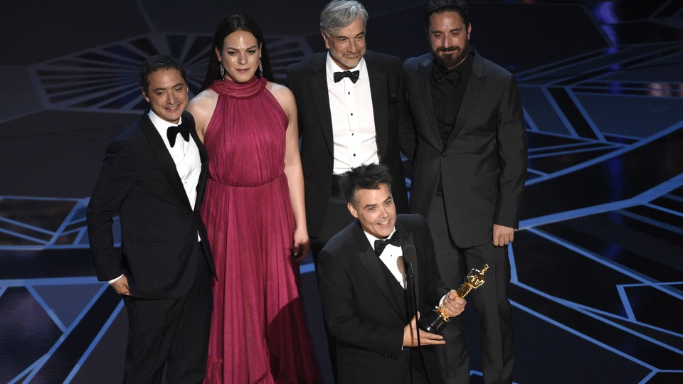 Sebastian Lelio, Juan de Dios Larrain, Daniela Vega, Francisco Reyes, and Pablo Larrain accept the award for Best Foreign Language Film for 'A Fantastic Woman' at the Oscars on Sunday, March 4, 2018, at the Dolby Theatre in Los Angeles