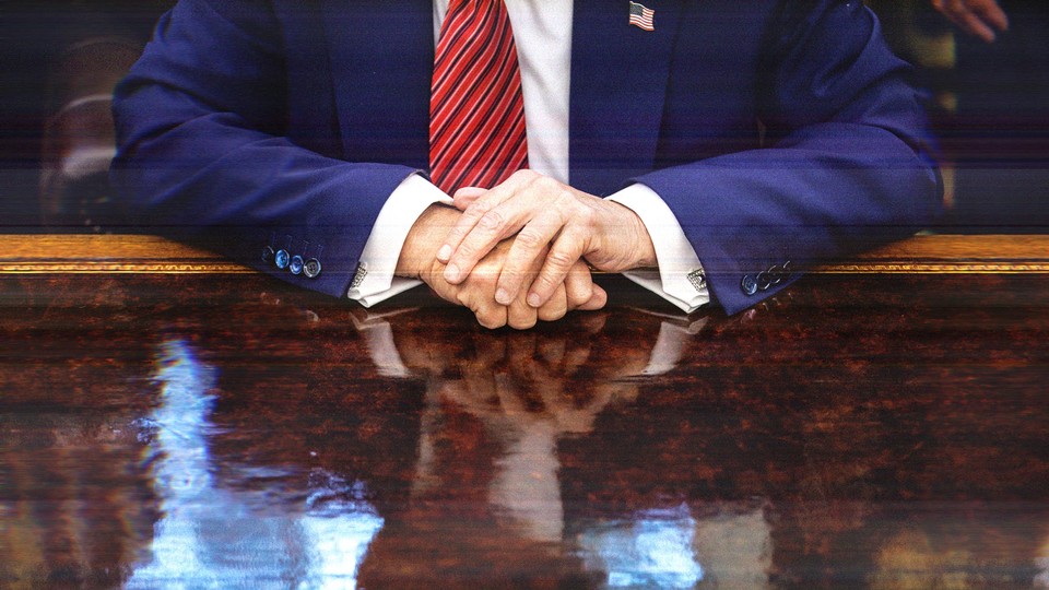 Close-up photo of Donald Trump's hands folded on his desk