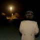 North Korean leader Kim Jong Un watches as a missile takes off. 