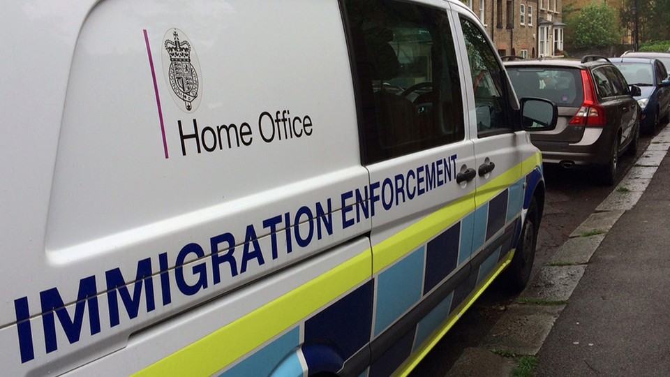 A British government Home Office van is seen with the words "immigration enforcement" along its side.