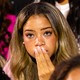 Black woman at an election watch party looking nervous