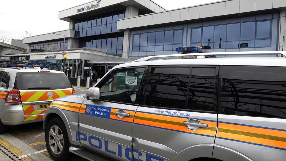 Police cars parked outside London City Airport on Tuesday