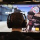 A gamer looking at a TV screen
