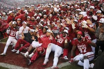 The Oklahoma Sooners pose for a photo with the Big 12 Championship trophy.