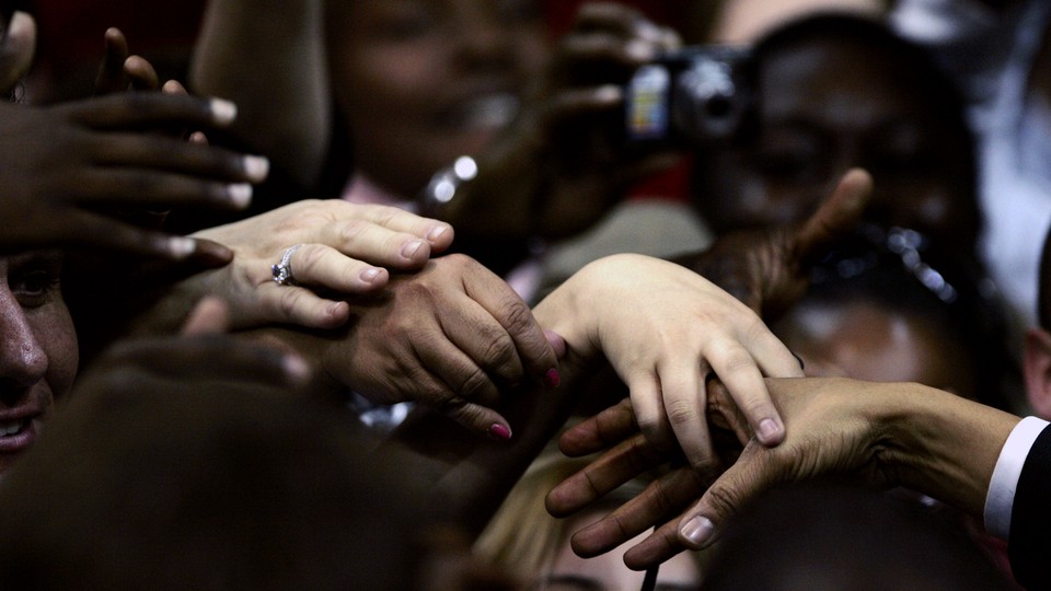 Supporters reach out to touch the hand of democratic presidential candidate Senator Obama