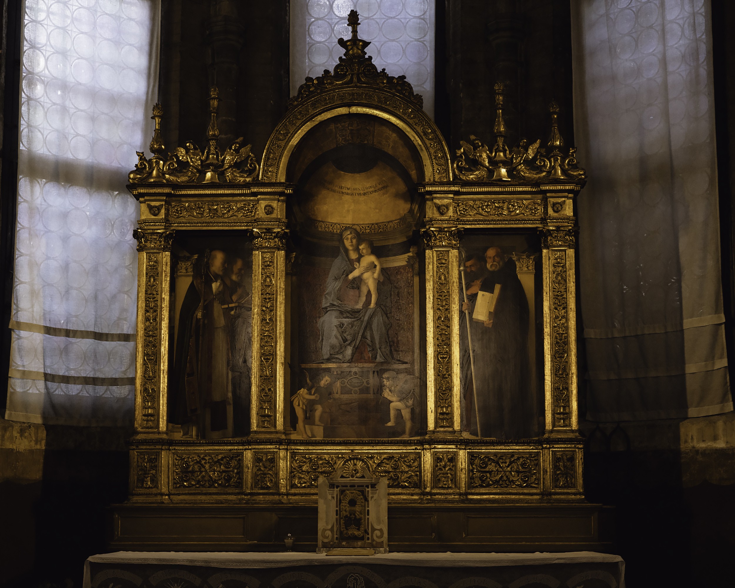 Inside of the  Basilica di Santa Maria Gloriosa dei Frari with a statue of Mary and Jesus