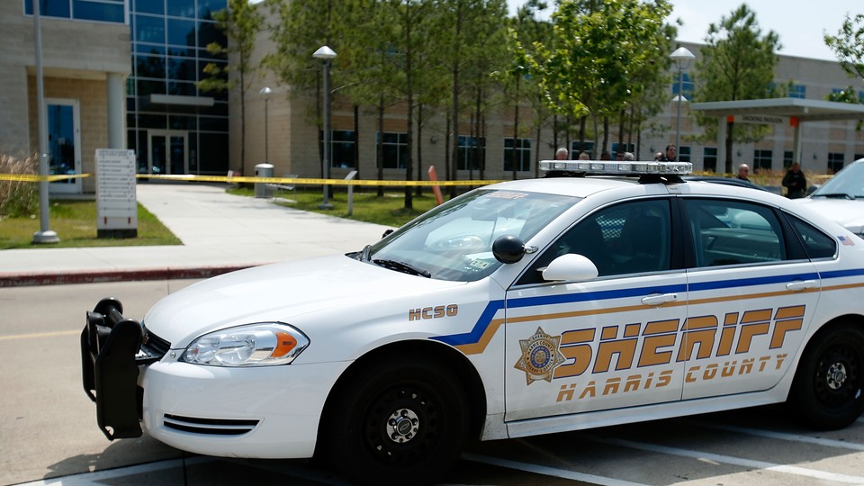 A Harris County sheriff car parked outside a school
