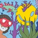 Two people snorkel on a colorful reef, where a smiley face is caught on a piece of coral