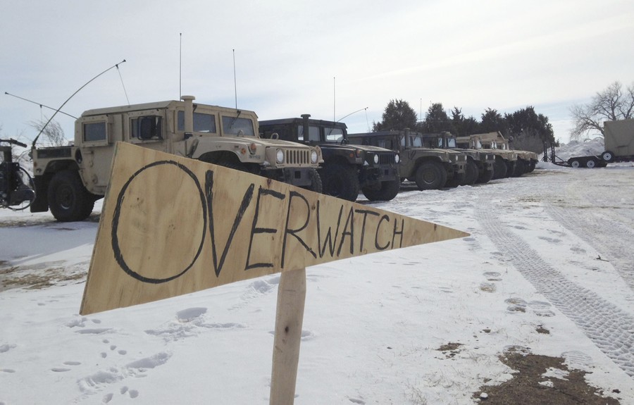 Military vehicles are staged near the path of the Dakota Access pipeline Thursday, February 9, 2017 near Cannon Ball, North Dakota. The developer says construction of the Dakota Access pipeline under a North Dakota reservoir has begun and that the full pipeline should be operational within three months.
