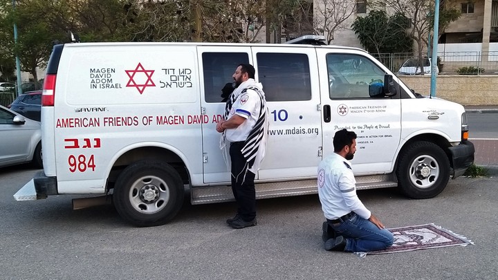 Two medics—one Jewish and one Muslim—praying in Israel.