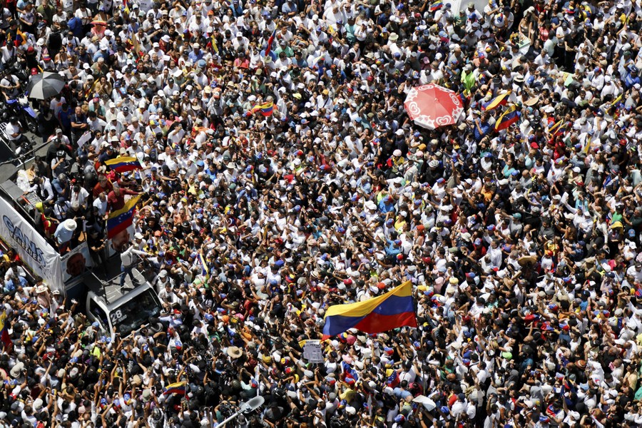 An elevated shot of a densely packed crowd of people at a political rally
