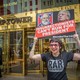 Participant seen holding a sign outside Trump Tower