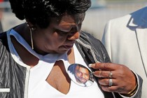 Valerie Castile, the mother of Philando Castile, looks at a photo button of her son in Saint Paul.