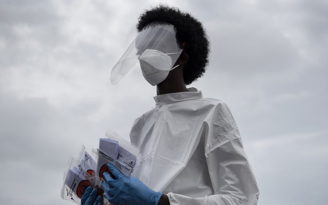 A health-care worker holding coronavirus tests