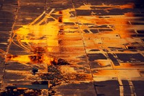 a puddle on the street, reflecting orange light