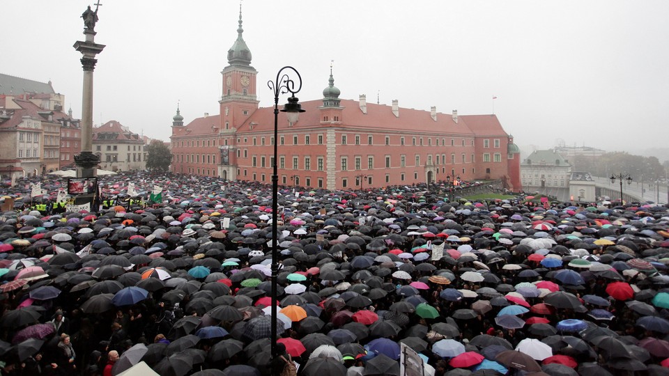 Thousands of people gather during an abortion-rights demonstration to protest against plans for a total ban on abortion in front of the Royal Castle in Warsaw, Poland, on October 3.