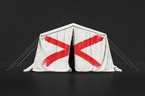 An illustration that depicts a USAID tent with a red "X" painted over it.