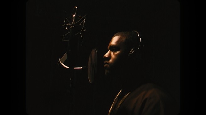Kanye West in front of a microphone