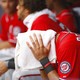 Washington Nationals shortstop Ian Desmond drapes a towel over his head to cool off in 100-degree heat.