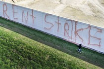 A building with "Rent Strike" written across it