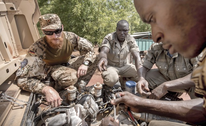 A German military instructor works with Mali soldiers during a training session.