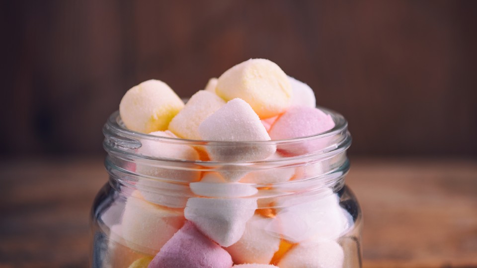 Mini multicolored marshmallows in a glass jar