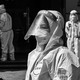 Workers and volunteers look on in a compound where residents are tested for the coronavirus during the second stage of a pandemic lockdown in Jing'an district, in Shanghai, on April 4, 2022.