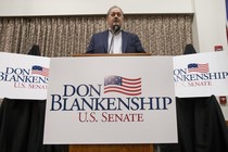 Don Blankenship, a Republican Senate candidate in West Virginia, surrounded by campaign signs.