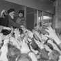 Ayatollah Ruhollah Khomeini greets a crowd of people waving their hands at him at Tehran University in 1979.