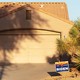A Biden sign outside of a house with an arid, western-looking yard
