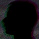 A man's silhouette in front of a background made up of repeating zeroes and ones
