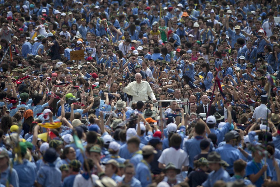 Pope Francis is cheered by a large crowd.