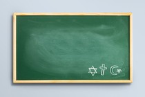 Picture showing green chalkboard with drawings of the Jewish star of David, the Christian cross, and the Muslim star and crescent.