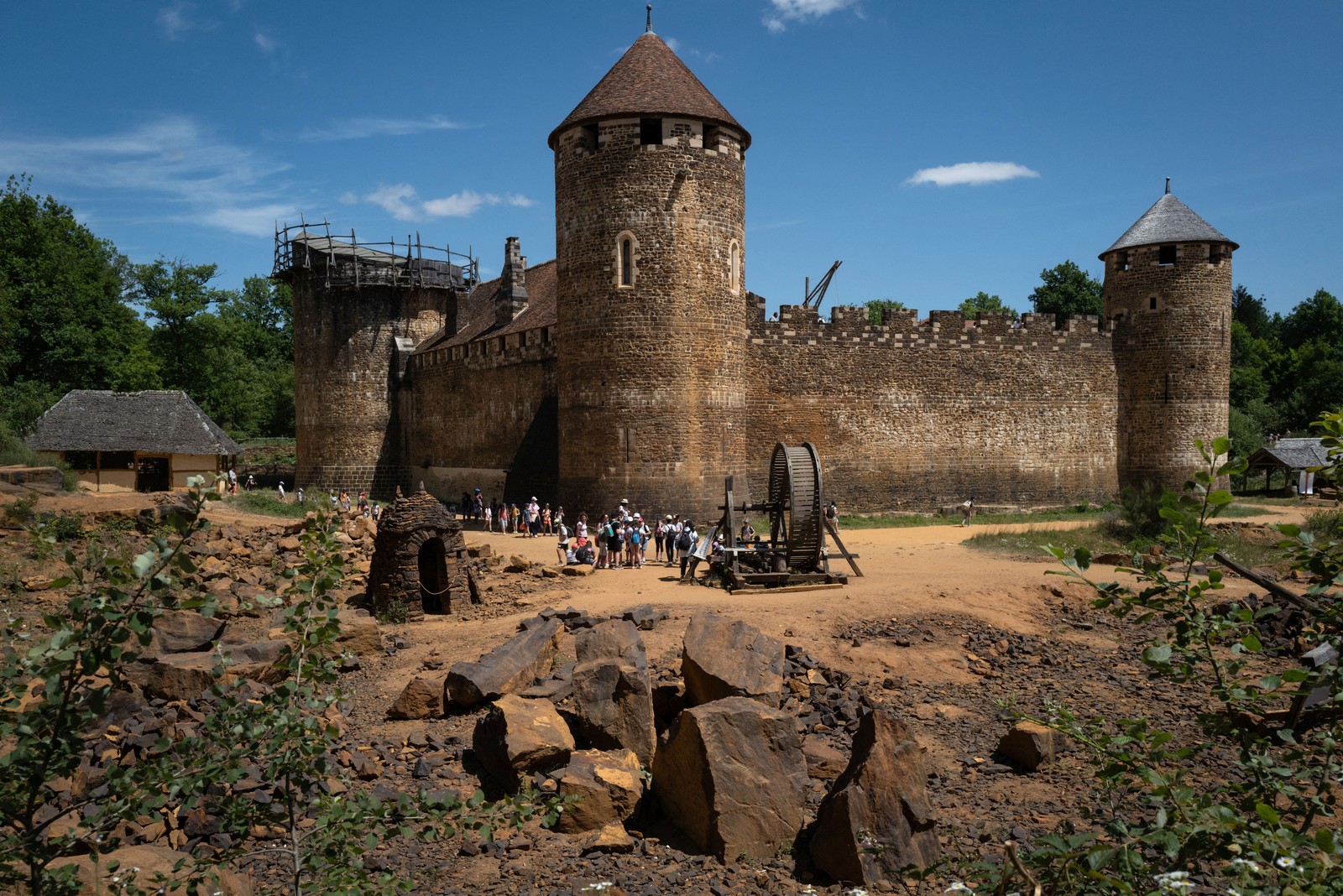 A school group walks outside a medieval-style castle.
