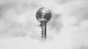 A grey key floats in the white and grey fog