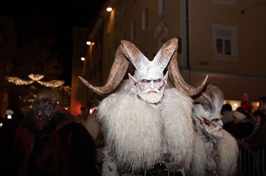 Several performers where menacing-looking Krampus costumes in a parade.