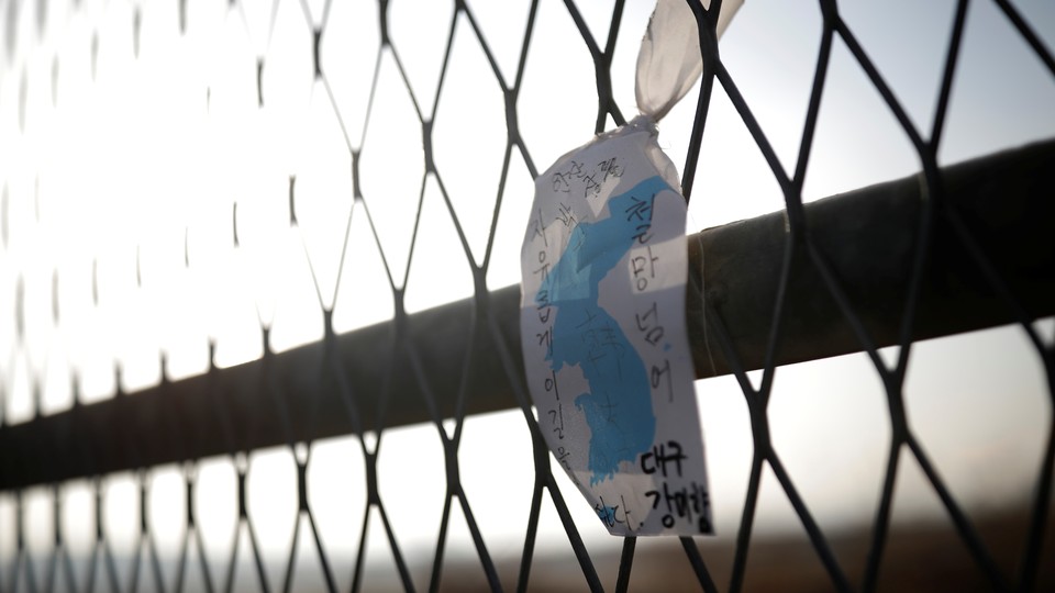 A Korean unity flag hangs on a fence in the demilitarized zone separating the two Koreas.